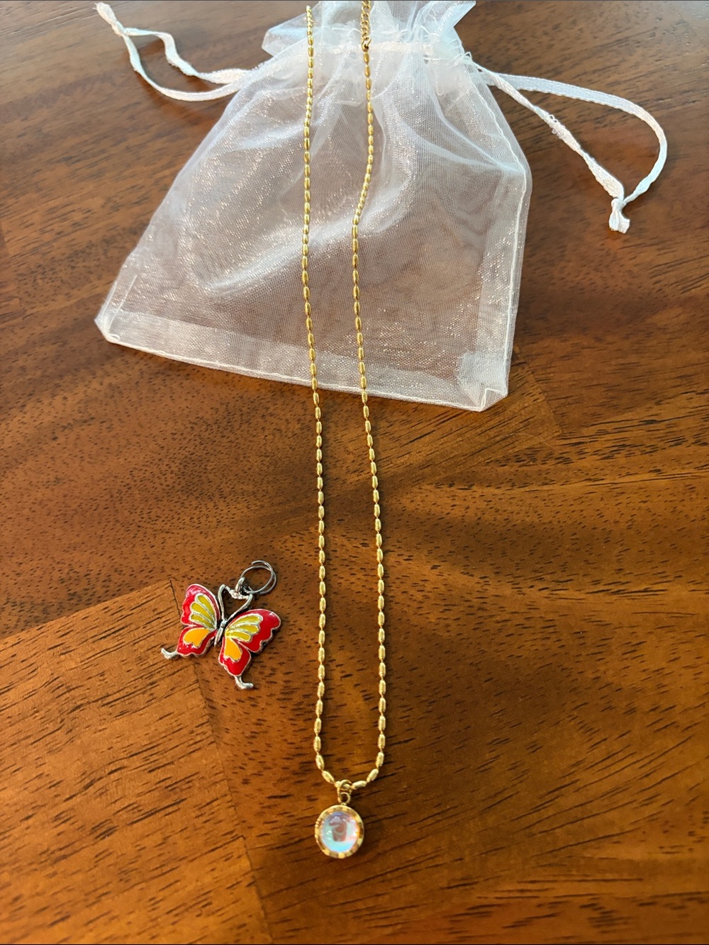 Gold Beaded Necklace with Pink Opalescent Pendant and Butterfly Pendant